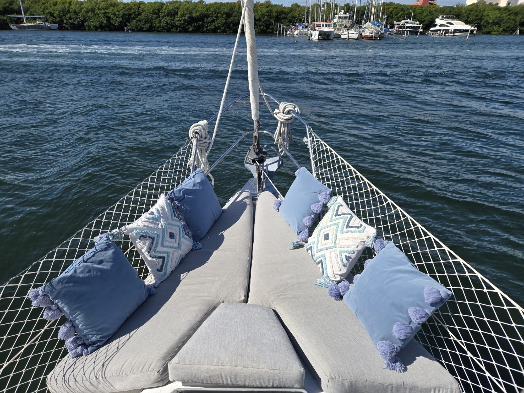 SISU foredeck with cushioned lounge and marina beyond