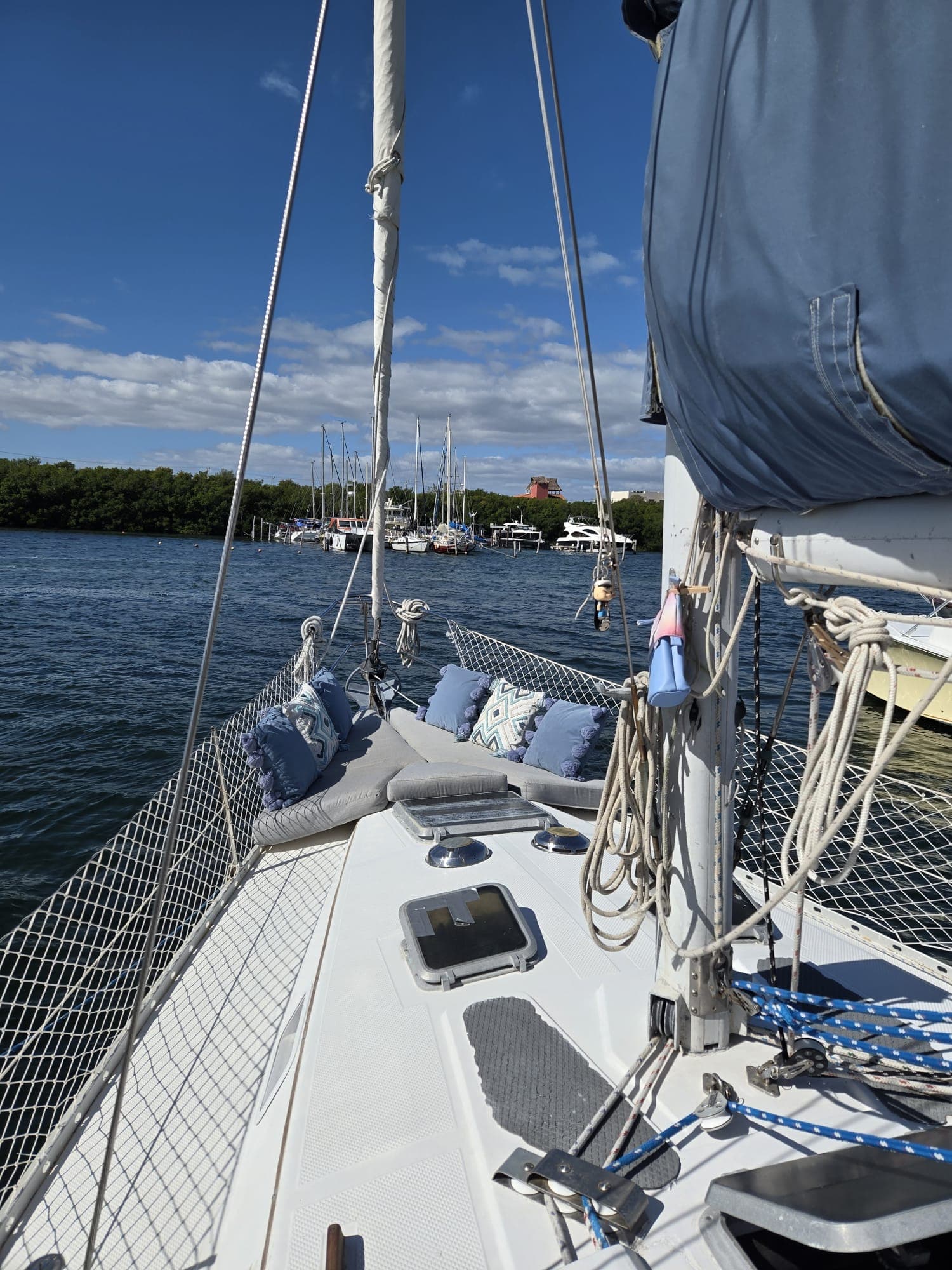 SISU foredeck with cushions, rigging and marina in the distance