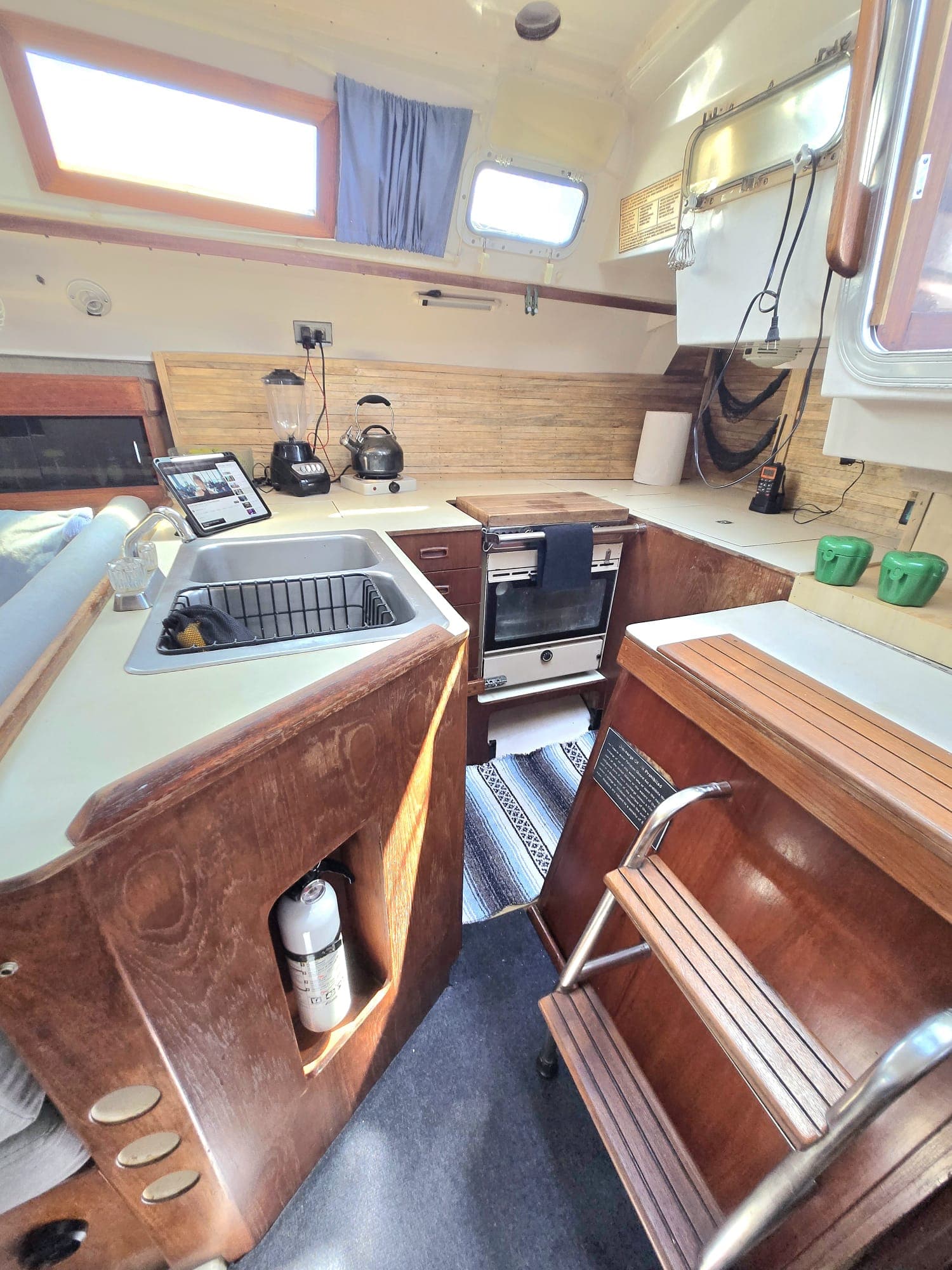 SISU galley with sink, stove, and warm mahogany cabinetry